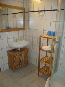 a bathroom with a sink and a shower at Waldhaus Sellin in Ostseebad Sellin +67 photos