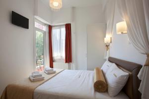 a hotel room with a bed and a window at Metropolis Hotel in Athens