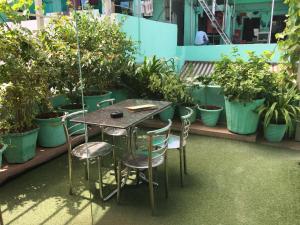 a table and chairs in a room with potted plants at Amax Inn in New Delhi