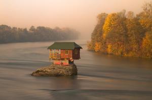 a house on a island in the middle of a river at Prenoćište i restoran Ihthis in Bajina Bašta