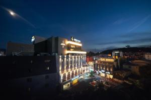 a lit up building in a city at night at Hotel Artheim in Gwangju