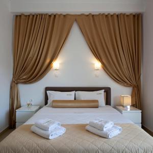 a bedroom with a bed with two towels on it at Metropolis Hotel in Athens