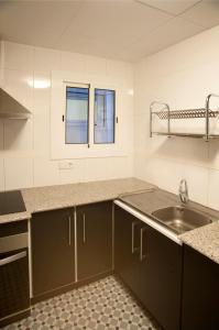 a kitchen with a sink and a counter top at El 3 del Holandés in Balaguer +20 photos