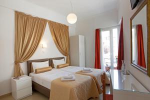 a bedroom with a bed with two towels on it at Metropolis Hotel in Athens