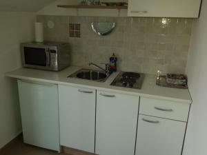Kuchyň nebo kuchyňský kout v ubytování Apartment Star