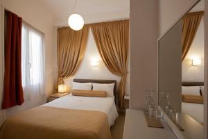 a bedroom with a bed and a large window at Metropolis Hotel in Athens