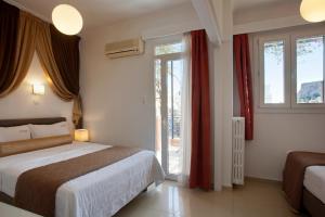 a hotel room with a bed and a window at Metropolis Hotel in Athens