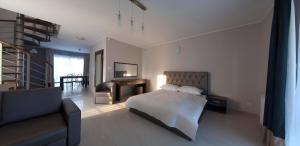 a bedroom with a bed and a chair and a couch at Villa BALTICA in Rowy