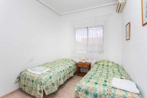 Postel nebo postele na pokoji v ubytování CH Isla Menorca Ciudad Quesada + 20 fotografií
