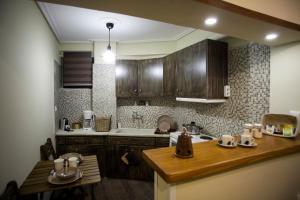 a kitchen with wooden cabinets and a wooden counter top at Petra house 2 in Arachova