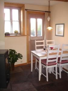 a dining room with a white table and chairs at Ferienhaus am Solling in Dassel