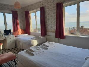 A bed or beds in a room at The Wight Bay Hotel - Isle of Wight