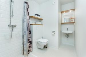 a bathroom with a toilet and a shower and a sink at Angleterre Apartments in Tallinn +86 photos