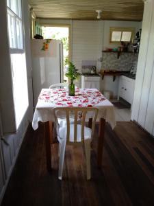 uma cozinha com uma mesa com uma toalha de mesa de flores em Casa na Praia do Matadeiro em Florianópolis