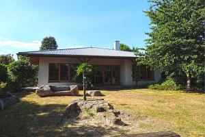 a small house with a tree in the yard at Haus Katha Koserow in Ostseebad Koserow