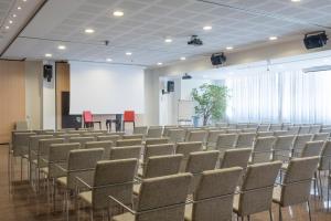 an empty lecture hall with chairs and a projection screen at Hotel San Marco Fitness Pool & Spa in Verona +37 photos