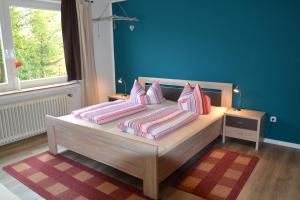 una camera da letto con un letto con cuscini sopra di Haus Steeg a Braunlage
