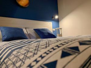 a bedroom with a bed with blue walls and blue pillows at Porta Ronca - B&B, Suites & Apts in Rho