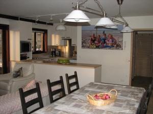 a kitchen and living room with a table and chairs at Residentie Beverly in Oostduinkerke
