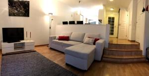 a living room with a couch and a tv at Arctic Sofia Riverstudio in Rovaniemi +16 photos