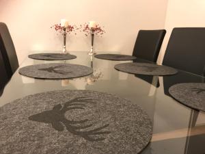 a table with four tables with candles on top at Arctic Sofia Riverstudio in Rovaniemi