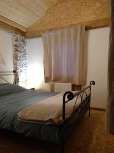 a bedroom with a large bed with a window at Elément-Terre in Aigle