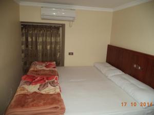 a bedroom with two beds and a window at Al Maghraby Hotel in Alexandria