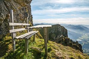 a wooden bench sitting on top of a mountain at Grillinghof in Kirchberg in Tirol +53 photos