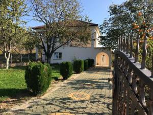 a walkway in front of a house with a fence at Holiday House Vego in Čapljina