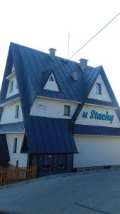 a building with a blue roof on top of it at Agrotatry U Stachy in Bukowina Tatrzańska