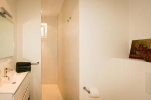 a white bathroom with a sink and a toilet at Park Appartement in Den Bosch