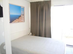 a bedroom with a bed with a view of the ocean at Romi' in Polignano a Mare