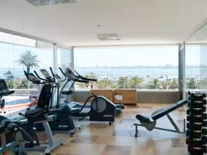 a gym with cardio machines and a large window at El más cool de la península. Gala Puerto. in Punta del Este