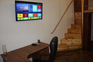 リヴィウにあるКвартира в центрі Львоваのデスク、壁掛けテレビが備わる客室です。