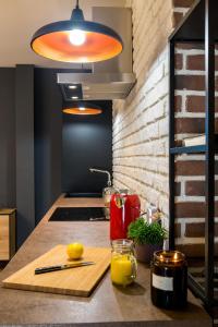 a kitchen counter with a cutting board and a light at Squirrel Apartment in Bucharest
