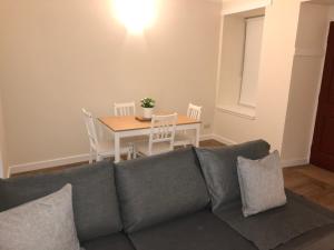 a living room with a couch and a table at 2 Lower Kessock Street in Inverness