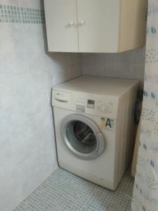 a washer and dryer in a small bathroom at Your Holiday Apartment in Kavála