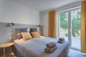 Posteľ alebo postele v izbe v ubytovaní Casa Mia Apartments + 37 fotografií