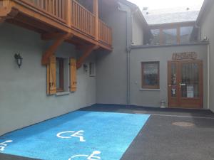 a building with a blue floor with a staircase on it at Auberge des Pyrénées in Sainte-Marie-de-Campan