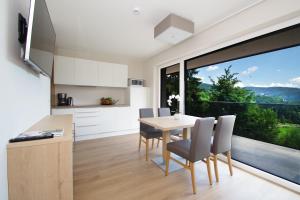 a kitchen and dining room with a table and chairs at Apartment Hotel Christine in Avelengo