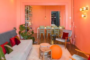 a living room with a couch and a table with chairs at AiR Waterfront Nikis Apartment in Thessaloniki