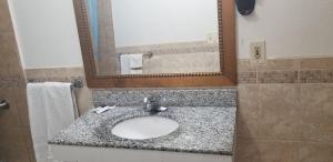 a bathroom with a sink and a mirror at Royal Inn Motel Long Beach in Long Beach