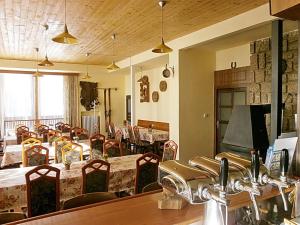 a restaurant with tables and chairs in a room at Hotel Vltava in Strážné