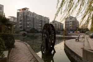 a large metal object in the water in a city at Henan Kaifeng·Gulou Square· Locals Apartment 00138460 in Kaifeng