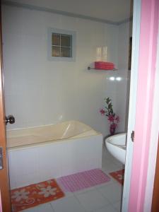 a bathroom with a bath tub and a toilet at Mary Chiang Baguio Transient House in Baguio +34 photos