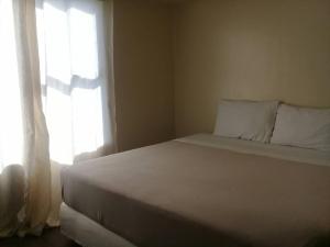 Ένα ή περισσότερα κρεβάτια σε δωμάτιο στο Soltana Nature Residences Condominium