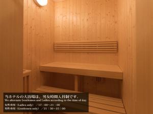 a sauna with wooden walls and a wooden bench at S.Training Center Hotel Osaka in Osaka