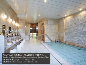 a large bathroom with sinks and a tub with mirrors at S.Training Center Hotel Osaka in Osaka