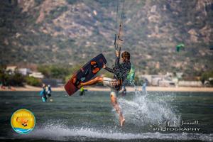 a man on a surfboard in the water at Phan rang kite center in Ấp Mỹ Hải