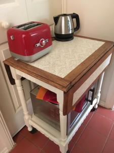 a table with a toaster on top of it at Belgrave Hideaway in Belgrave